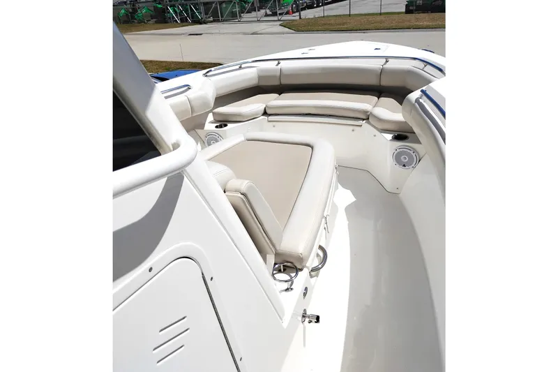 Slide: The Image of 2018 Boston Whaler 280 Outrage boat interior with cushioned seating and speakers. - 23