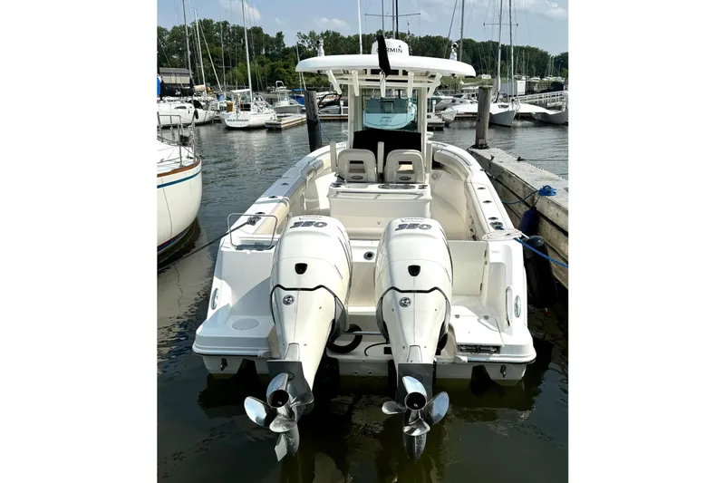 Slide: The Image of 2018 Boston Whaler 280 Outrage boat docked with twin engines, in a marina setting. - 3