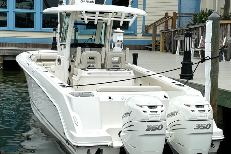 Slide: The Image of 2018 Boston Whaler 280 Outrage docked, featuring twin Mercury 350 engines. - 4