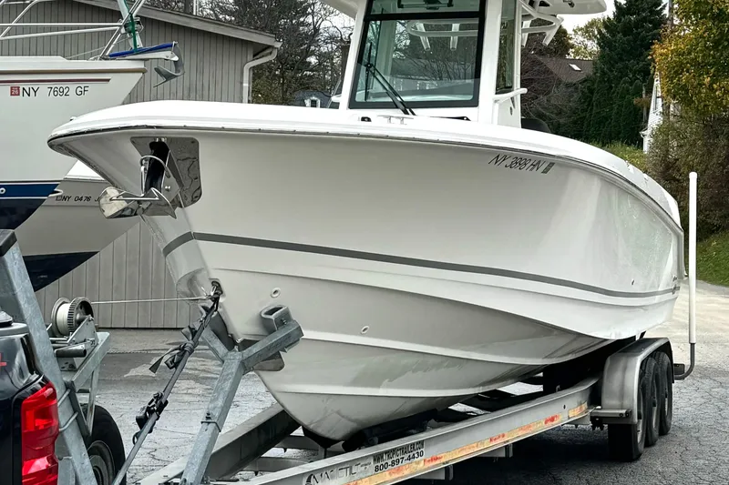 Slide: The Image of 2018 Boston Whaler 280 Outrage boat on trailer, parked outdoors. - 6