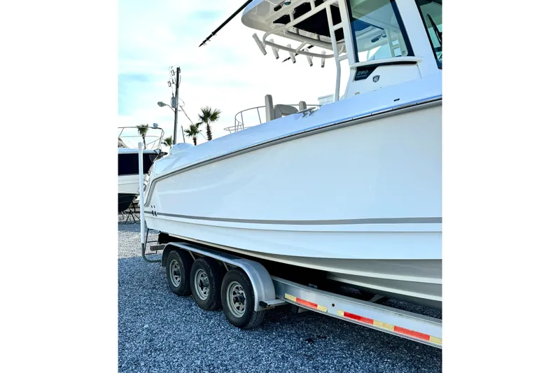 Slide: The Image of 2018 Boston Whaler 280 Outrage boat on trailer, side view. - 8