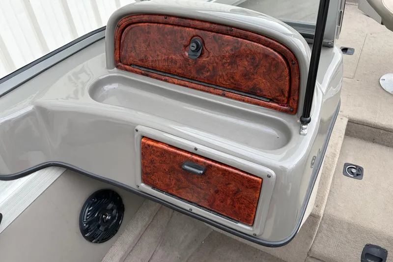 Slide: The Image of 2004 Bass Tracker Tournament V-18 boat interior with wood paneling and speaker. - 15