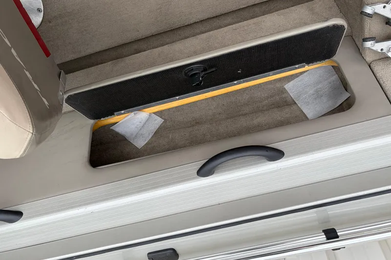 Slide: The Image of Open storage compartment in a 2004 Bass Tracker Tournament V-18 boat interior. - 18