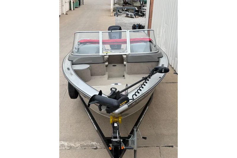 Slide: The Image of 2004 Bass Tracker Tournament V-18 boat on trailer, parked outdoors. - 3
