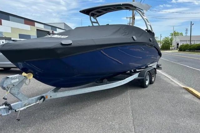 Slide: The Image of 2022 Yamaha Boats 252SD on trailer, covered, parked outdoors. - 2