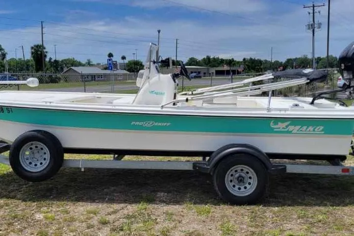 The Image of 2020 Mako Pro Skiff 19 CC boat on trailer, parked outdoors under clear sky. - 1
