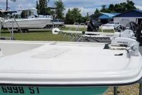 Slide: The Image of 2020 Mako Pro Skiff 19 CC boat with trolling motor in a marina setting. - 6