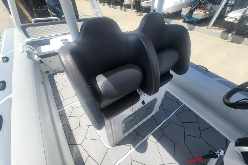 Slide: The Image of 2024 Highfield Sport 760 boat interior with dual black seats and geometric flooring. - 4