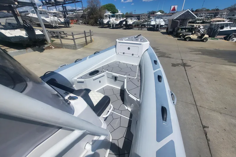 Slide: The Image of 2024 Highfield Sport 760 boat docked, showcasing sleek design and spacious deck layout. - 6