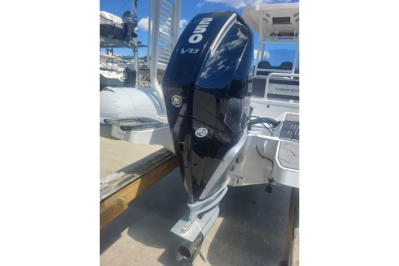 Slide: The Image of 2024 Highfield Sport 760 boat with powerful 250 V8 engine, docked under clear blue sky. - 7
