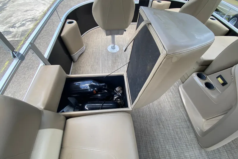 Slide: The Image of 2023 Starcraft SF 16 DLX boat interior with open storage compartment and seating. - 11