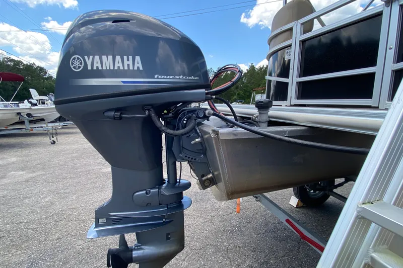 Slide: The Image of 2023 Starcraft SF 16 DLX with Yamaha four-stroke outboard motor, parked outdoors. - 15
