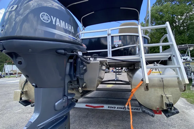 Slide: The Image of 2023 Starcraft SF 16 DLX pontoon boat with Yamaha motor on trailer. - 16