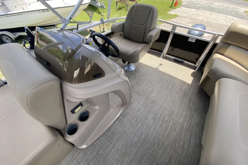 Slide: The Image of 2023 Starcraft SF 16 DLX boat interior with beige seating and steering console. - 7