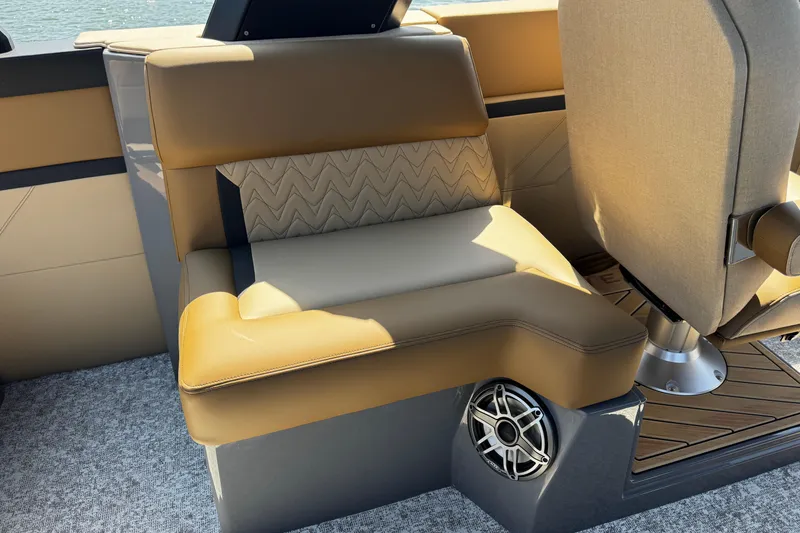 Slide: The Image of Luxurious seating on 2026 Revel RS25L boat with premium upholstery and integrated speaker. - 10