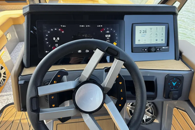 Slide: The Image of 2026 Revel RS25L boat dashboard with modern steering wheel and digital displays. - 13