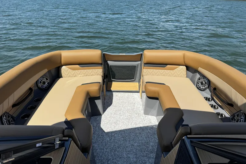 Slide: The Image of Luxurious 2026 Revel RS25L boat interior with tan seating on a serene lake. - 14