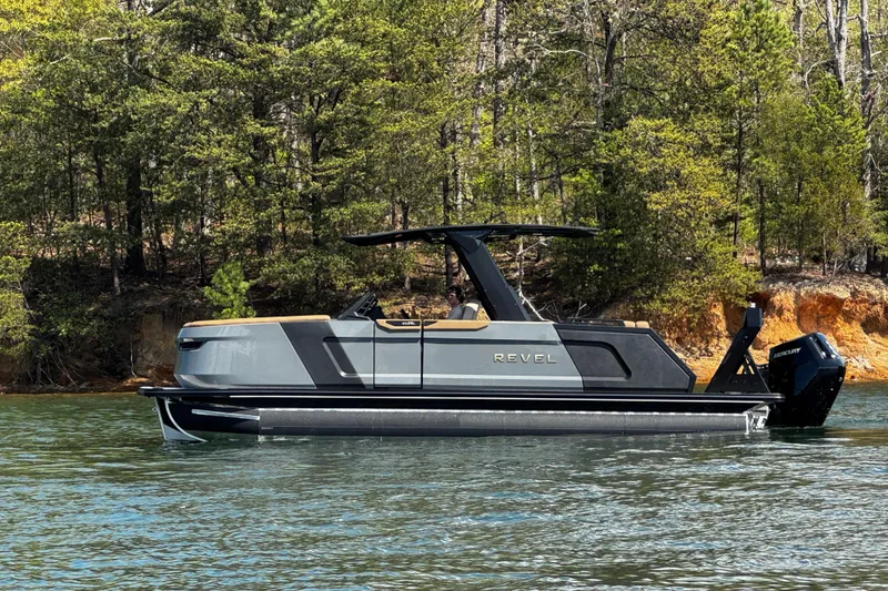 Slide: The Image of 2026 Revel RS25L boat on a serene lake, surrounded by lush trees. - 7