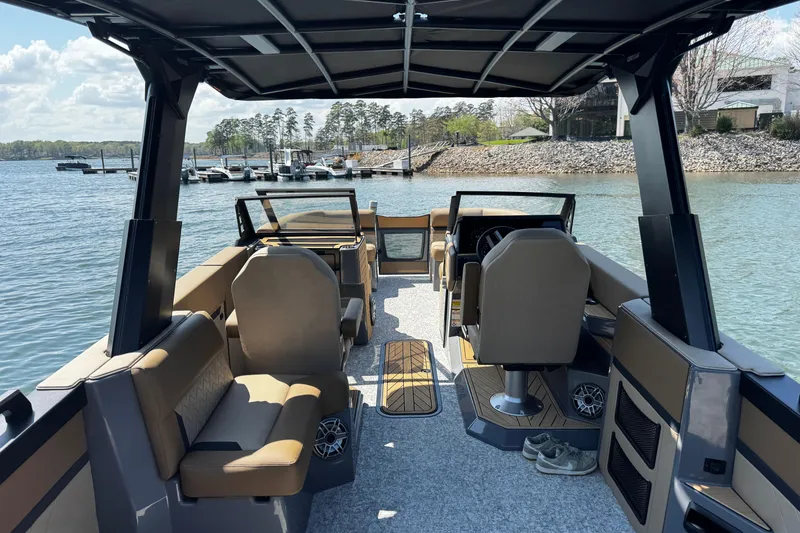 Slide: The Image of Modern 2026 Revel RS25L boat interior with seating, steering, and lake view. - 9