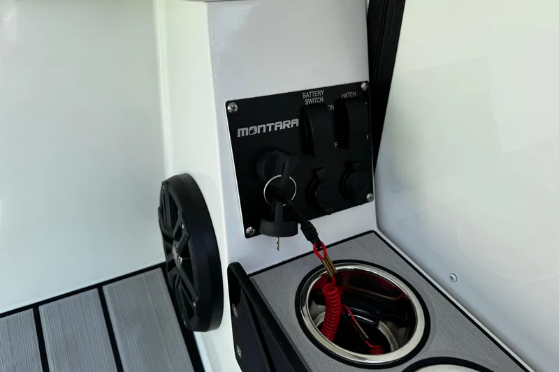 Slide: The Image of Control panel of a 2021 Montara 25 boat with key and cup holder. - 17