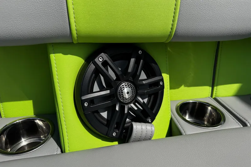 Slide: The Image of Speaker and cup holders on 2021 Montara 25 boat with green and gray upholstery. - 19