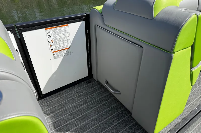 Slide: The Image of 2021 Montara 25 boat interior with gray and green seating, safety instructions visible. - 20