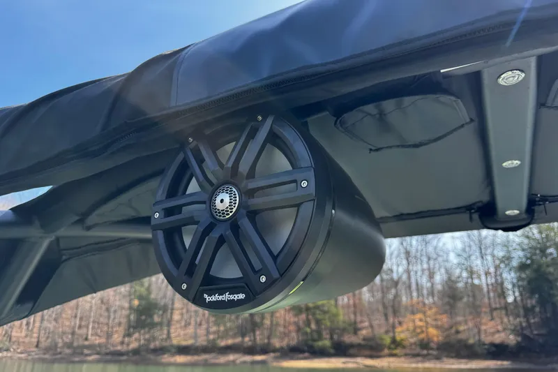Slide: The Image of Rockford Fosgate speaker on 2021 Montara 25 boat, mounted under canopy, outdoor setting. - 21