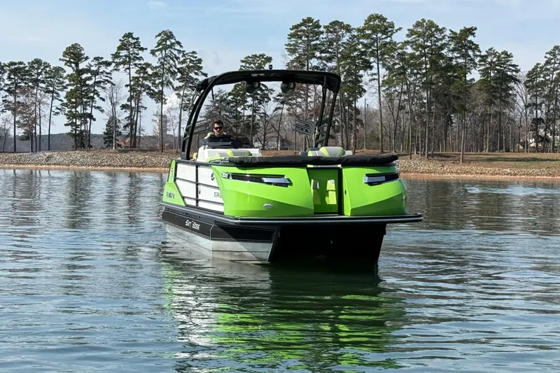 Slide: The Image of 2021 Montara 25 boat on a calm lake with trees in the background. - 3