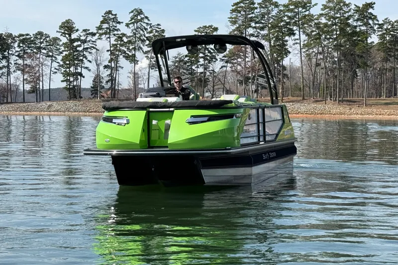 Slide: The Image of 2021 Montara 25 boat on a calm lake with trees in the background. - 4