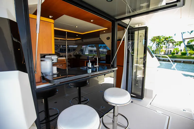 Slide: The Image of Interior of 2017 Aquila 44 Yacht featuring modern kitchen and bar stools. - 36