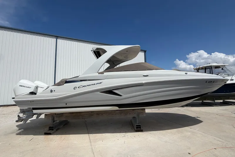 The Image of 2019 Crownline Eclipse E295 XS boat with Mercury engines, displayed outdoors under a clear blue sky. - 0