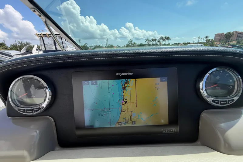 Slide: The Image of Dashboard of 2019 Crownline Eclipse E295 XS with navigation display and gauges. - 10