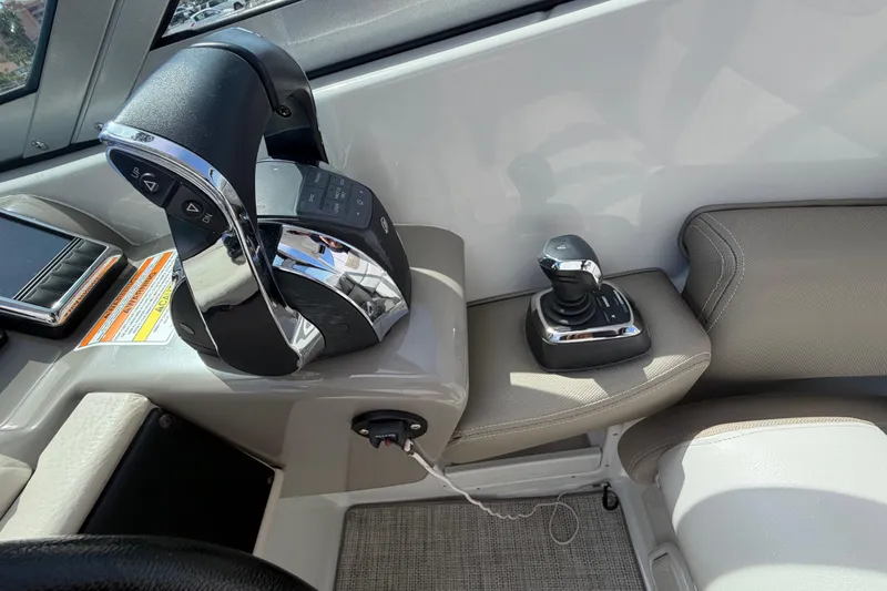 Slide: The Image of 2019 Crownline Eclipse E295 XS boat controls with joystick and throttle lever. - 11
