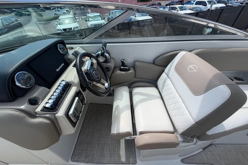 Slide: The Image of 2019 Crownline Eclipse E295 XS boat cockpit with steering wheel and plush seating. - 12