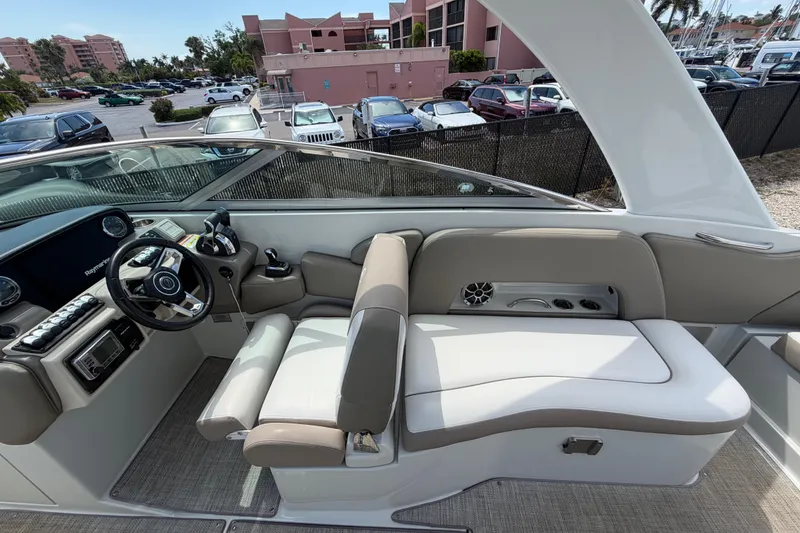 Slide: The Image of 2019 Crownline Eclipse E295 XS boat interior with steering wheel and seating area. - 14