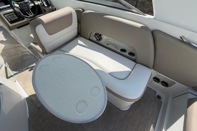 Slide: The Image of 2019 Crownline Eclipse E295 XS boat interior with seating and table setup. - 15