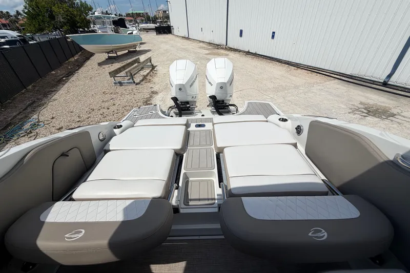 Slide: The Image of 2019 Crownline Eclipse E295 XS boat with dual outboard engines and spacious seating area. - 22