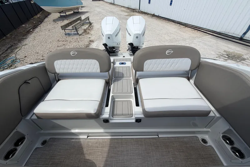 Slide: The Image of 2019 Crownline Eclipse E295 XS boat interior with dual seating and twin Mercury outboard engines. - 23