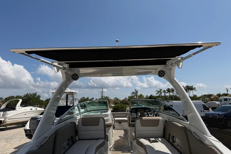 Slide: The Image of 2019 Crownline Eclipse E295 XS boat interior with canopy, showcasing seating and dashboard. - 25