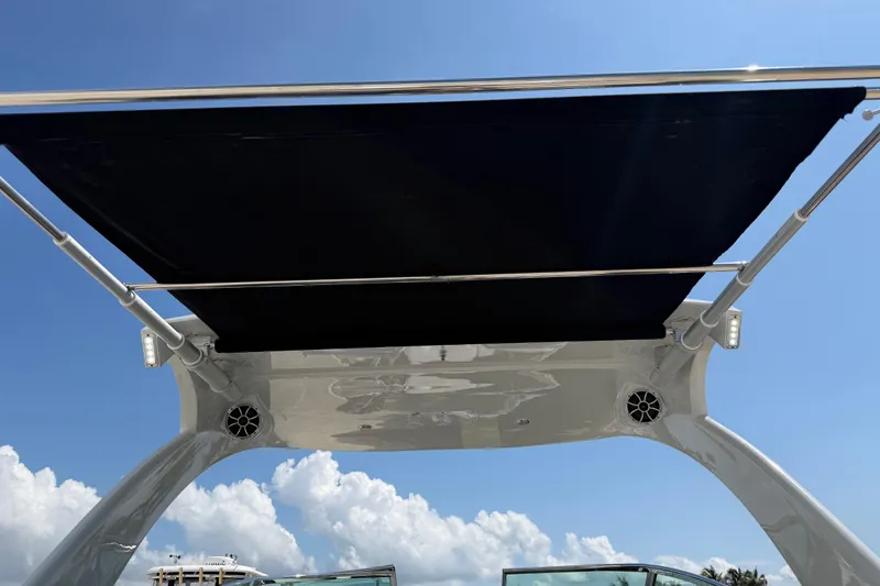 Slide: The Image of 2019 Crownline Eclipse E295 XS boat canopy under clear blue sky. - 26