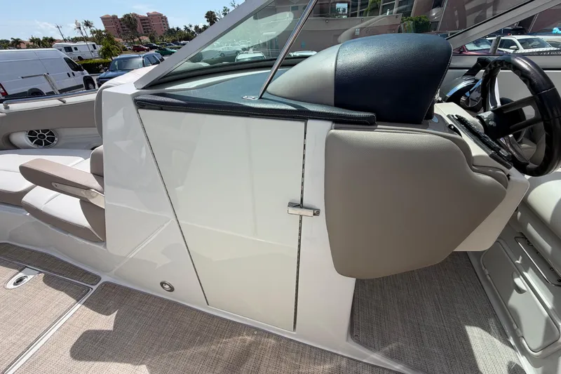 Slide: The Image of 2019 Crownline Eclipse E295 XS boat interior with seating and steering wheel. - 32