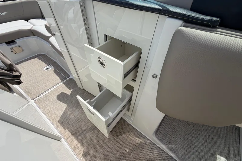 Slide: The Image of 2019 Crownline Eclipse E295 XS boat interior with open storage drawers. - 33