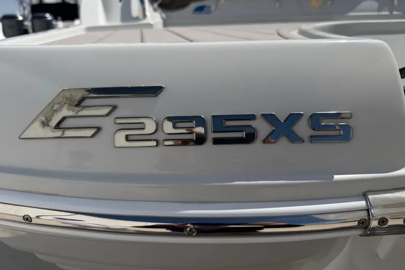 Slide: The Image of 2019 Crownline Eclipse E295 XS boat emblem on white surface. - 34
