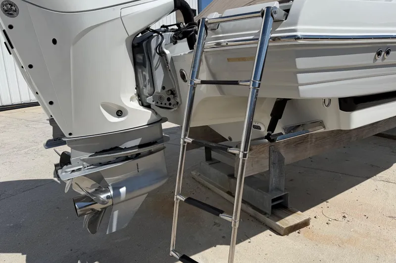 Slide: The Image of 2019 Crownline Eclipse E295 XS boat with outboard motor and boarding ladder. - 35