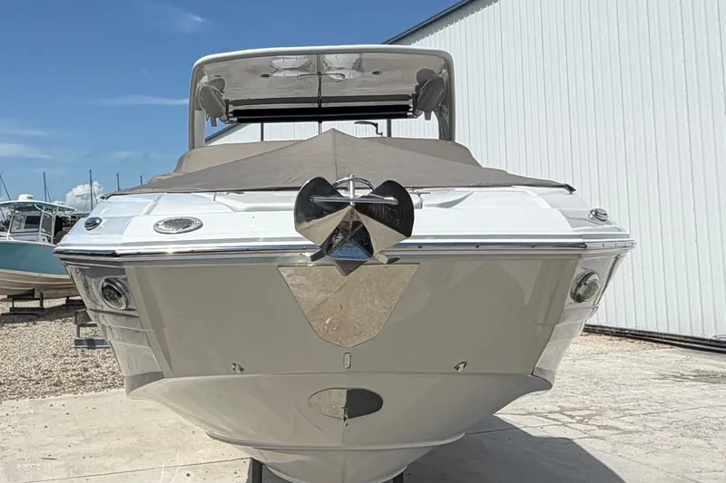 Slide: The Image of 2019 Crownline Eclipse E295 XS boat with covered bow, docked outdoors. - 6