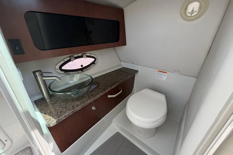 Slide: The Image of 2019 Crownline Eclipse E295 XS boat bathroom with modern sink and toilet. - 8