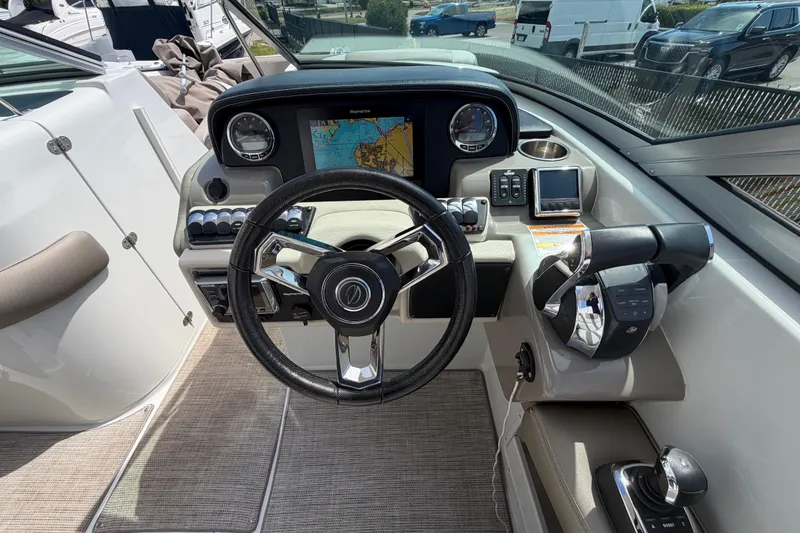 Slide: The Image of Cockpit of 2019 Crownline Eclipse E295 XS boat with steering wheel and navigation system. - 9