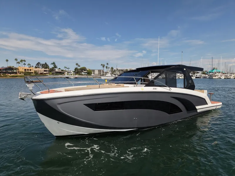 Slide: The Image of The image shows a modern motorboat floating on calm water, featuring a sleek black and white design. - 11
