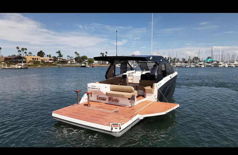 Slide: The Image of The image shows a modern motorboat on calm water. It features an open deck and a stylish cabin. - 5