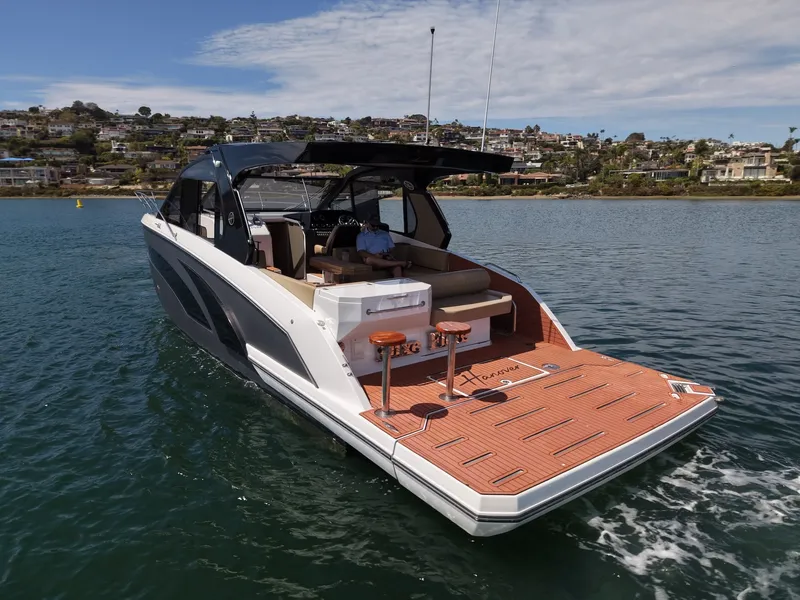 Slide: The Image of The image shows a modern motor yacht on the water with a spacious deck and sleek lines. - 3